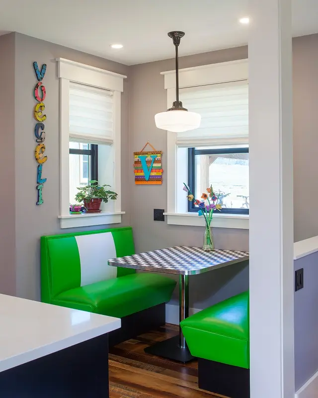 Retro kitchen nook in Crested Butte with bright green booth seating, checkered tabletop, and mid-century pendant lighting.